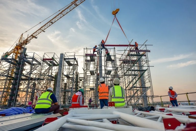 workers standing in front of a construction project