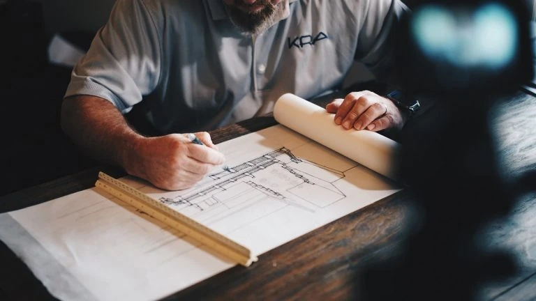 man working on construction plans