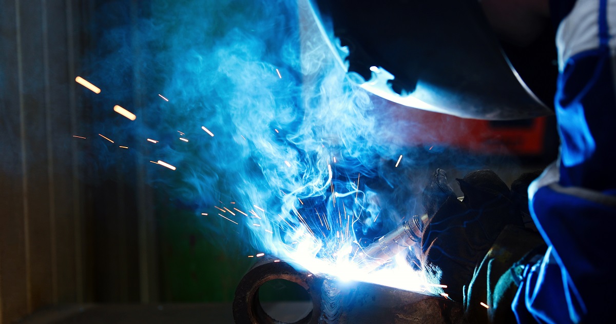 Metal worker welding in metal industry factory