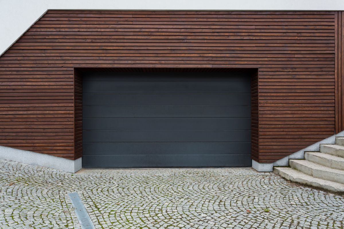 A garage with black painted steel door