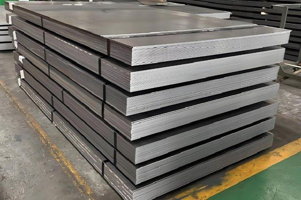Bundled mild steel plates stacked for inspection inside an industrial warehouse